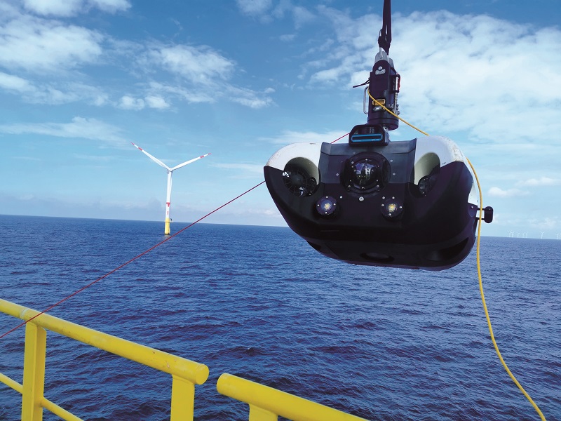 The HAUV being hauled onto a wind turbine’s transition piece deck using a crane (which work-class ROVs are largely too heavy for), before being activated and lowered into the water