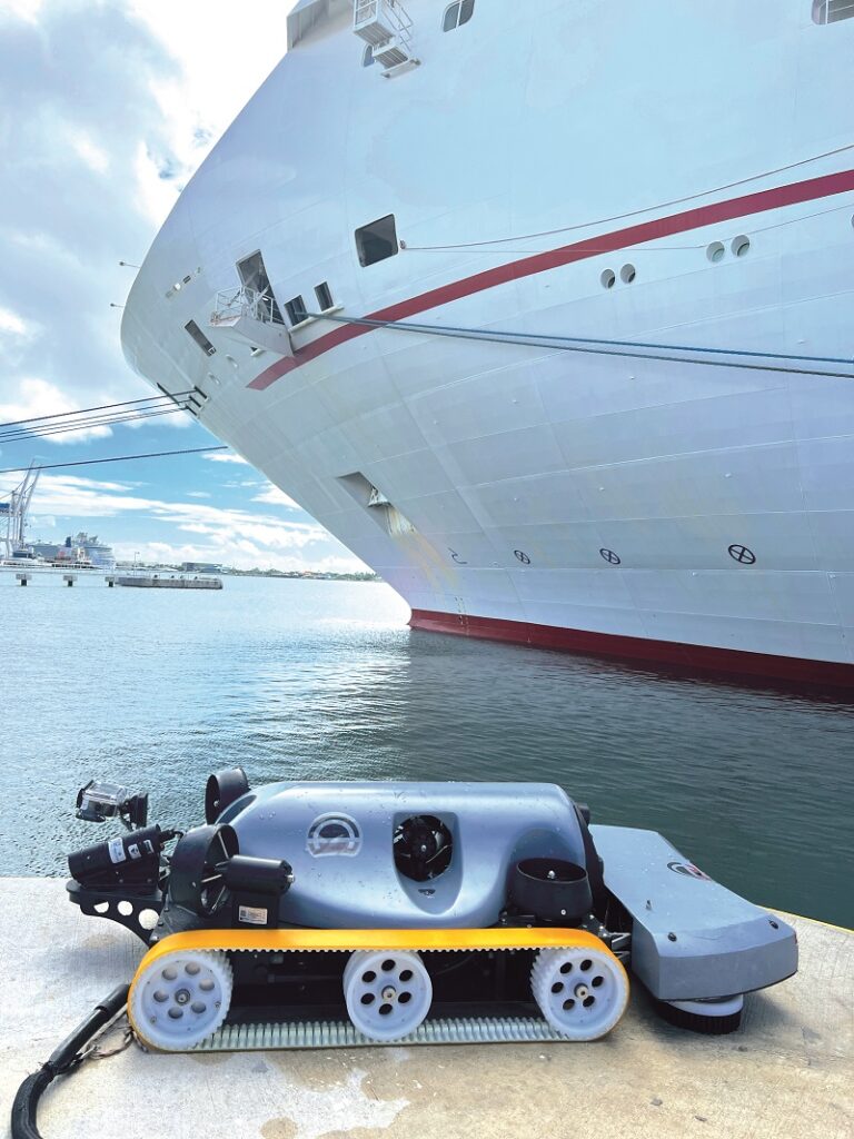 Armach’s Hull Service Robot ready to clean a cruise ship’s hull, showing thrusters, rubber tracks, brush head and the powercommand and control tether (Images courtesy of Armach Robotics)