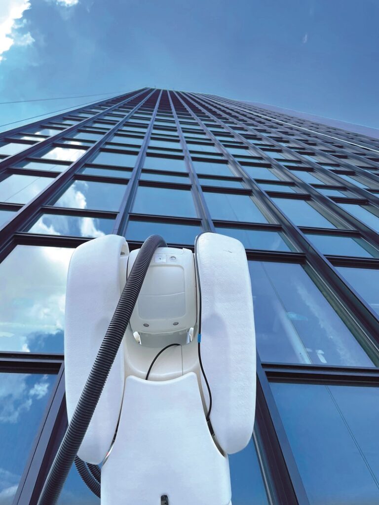 The Ozmo relies on a powerdata cable and a water hose that run from the building roof, both of which presented engineering challenges (Courtesy of Skyline Robotics)