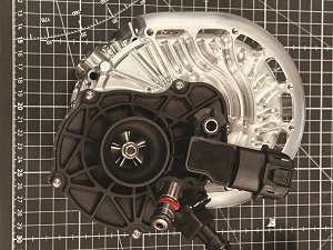While the RW1-300 is liquid-cooled, the RW1-79 is air-cooled via its supercharger pulling intake air through its motor with that air then being distributed into the ribs about the mid-housing