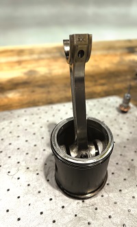 In addition to the liquid cooling concentrated about the cylinders and heads, squirters in the crankcase cool the undersides of the pistons by shooting oil at them
