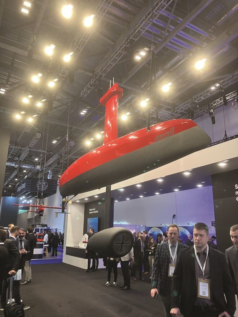 Oceanology International 2024 delegates check out the Exail stand with its DriX USV and FlipiX remotely-operated tow vehicle at the ExCeL
(Image courtesy of the author)