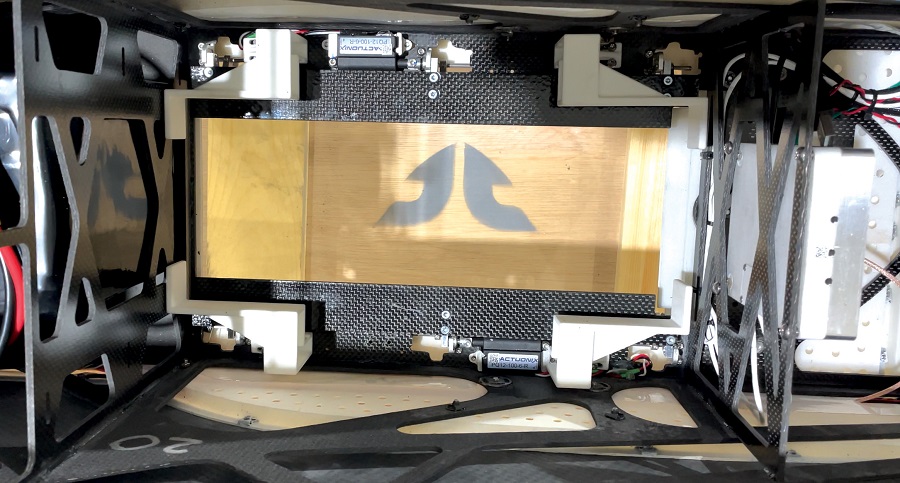 View down into the payload bay, revealing the 3D-printed load-bearing structure, along with payload bay-door actuators. Payloads can be lifted out or dropped or, as a later option, winched down